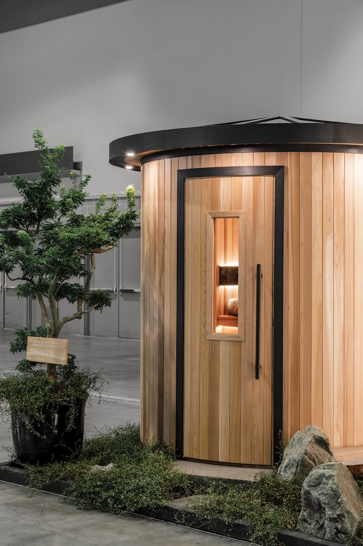 Custom cylinder sauna with window displayed at a show